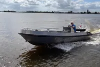 2018 Alufleet Tourer 555 boat cruising on a lake under cloudy skies.