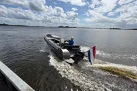 2018 Alufleet Tourer 555 boat cruising on a lake under a cloudy sky.