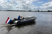 2018 Alufleet Tourer 555 boat with Dutch flag on a calm lake.