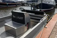 Alufleet Tourer 555 boat, 2018 model, docked at a marina with other boats.