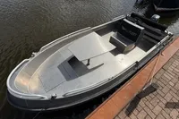 2018 Alufleet Tourer 555 boat docked, featuring sleek aluminum design and spacious seating.