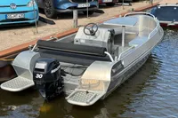 2018 Alufleet Tourer 555 boat with Mercury 30 engine docked by the water.