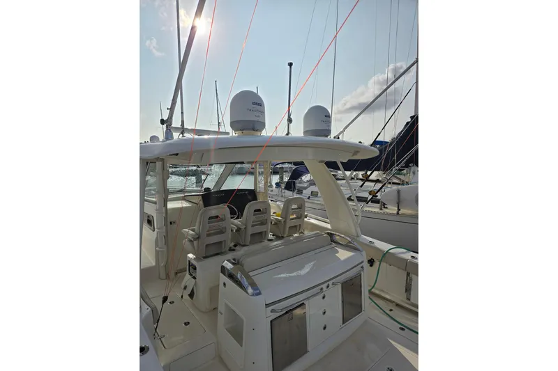  Yacht Photos Pics 2019 Boston Whaler 420 Outrage boat interior with seating and equipment, docked at marina.