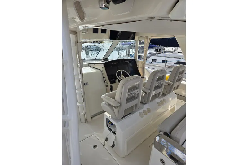  Yacht Photos Pics 2019 Boston Whaler 420 Outrage helm with three seats and modern controls.