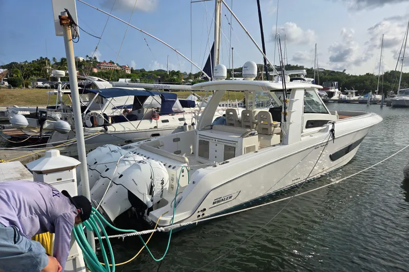  Yacht Photos Pics 2019 Boston Whaler 420 Outrage docked at marina with multiple outboard engines.