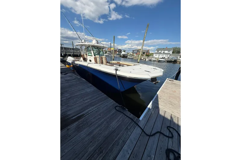  Yacht Photos Pics 2024 Caymas 34 CT boat docked, featuring sleek design and spacious deck under a clear sky.
