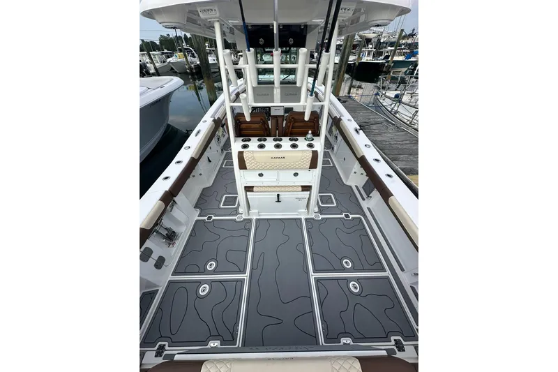  Yacht Photos Pics 2024 Caymas 34 CT boat interior with sleek gray deck and fishing rod holders.