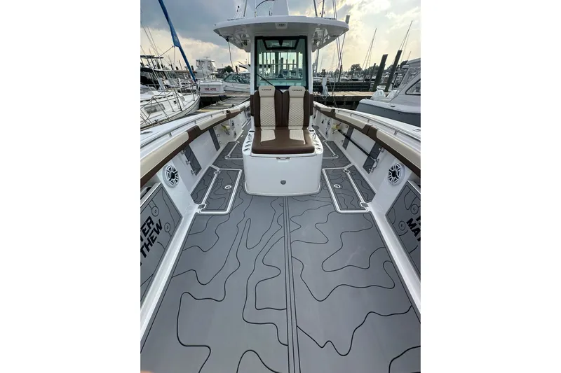  Yacht Photos Pics 2024 Caymas 34 CT boat interior with sleek seating and modern design at a marina.