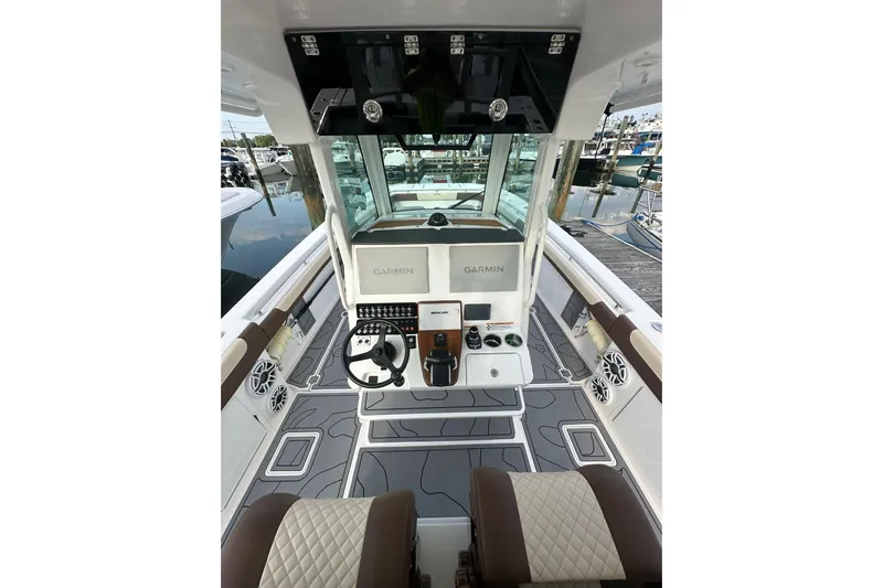  Yacht Photos Pics 2024 Caymas 34 CT boat cockpit with Garmin navigation, luxurious seating, and modern controls.