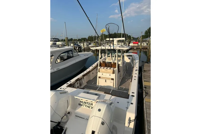  Yacht Photos Pics 2024 Caymas 34 CT boat docked at marina, featuring fishing equipment and spacious deck.