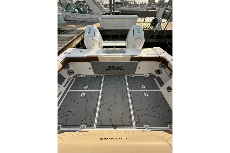  Yacht Photos Pics 2024 Caymas 34 CT boat deck with custom flooring and seating at a marina.