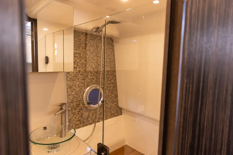  Yacht Photos Pics Modern bathroom in 2026 Hanover 387 with glass sink and mosaic tiles.