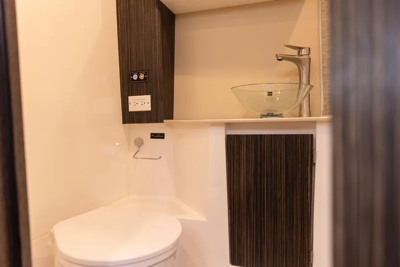  Yacht Photos Pics Modern bathroom in 2026 Hanover 387 with glass sink and sleek design.