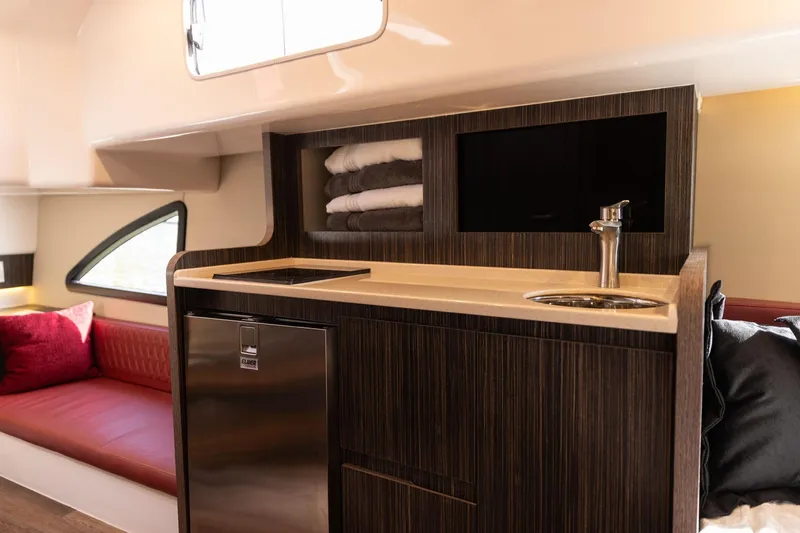  Yacht Photos Pics Luxurious interior of 2026 Hanover 387 yacht with kitchenette and seating area.