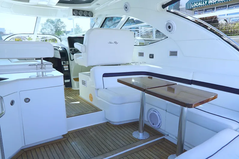 Door V Door Yacht Photos Pics Interior of 2011 Sea Ray 470 Sundancer yacht with sleek seating and wooden table.