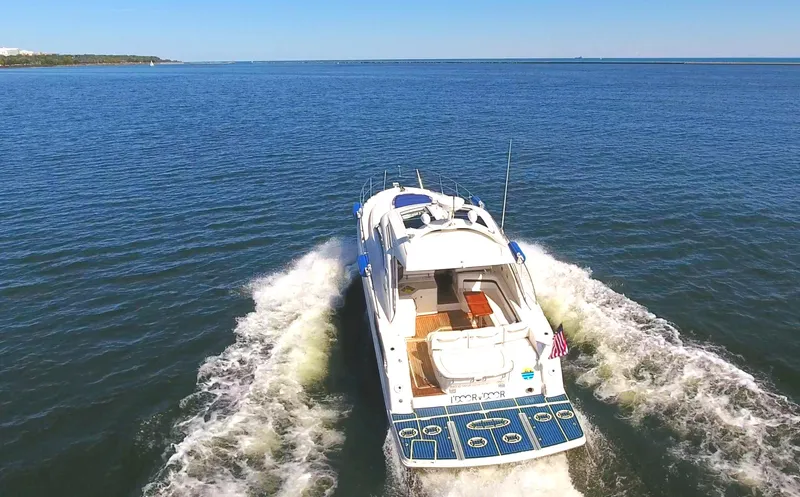 Door V Door Yacht Photos Pics 2011 Sea Ray 470 Sundancer cruising on open water, rear view.