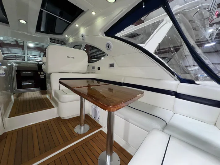 Door V Door Yacht Photos Pics Luxurious interior of 2011 Sea Ray 470 Sundancer yacht with elegant seating and wooden table.