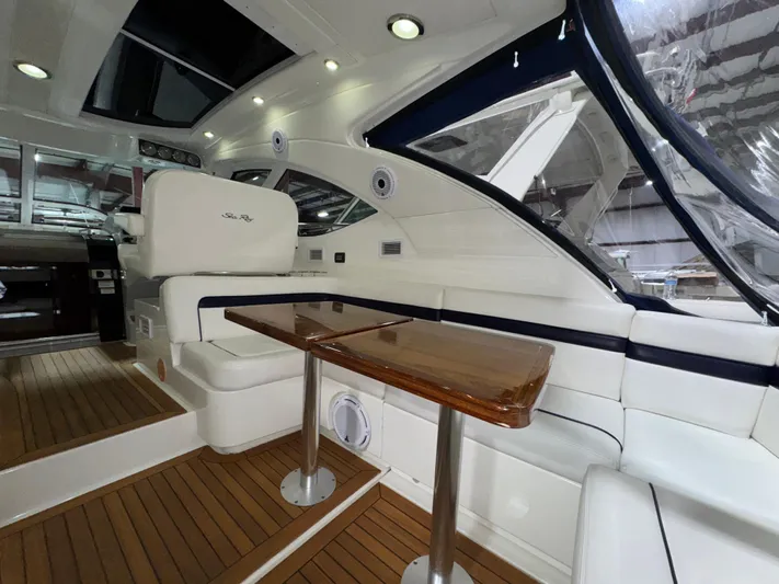 Door V Door Yacht Photos Pics Luxurious interior of 2011 Sea Ray 470 Sundancer yacht with elegant seating and wooden table.