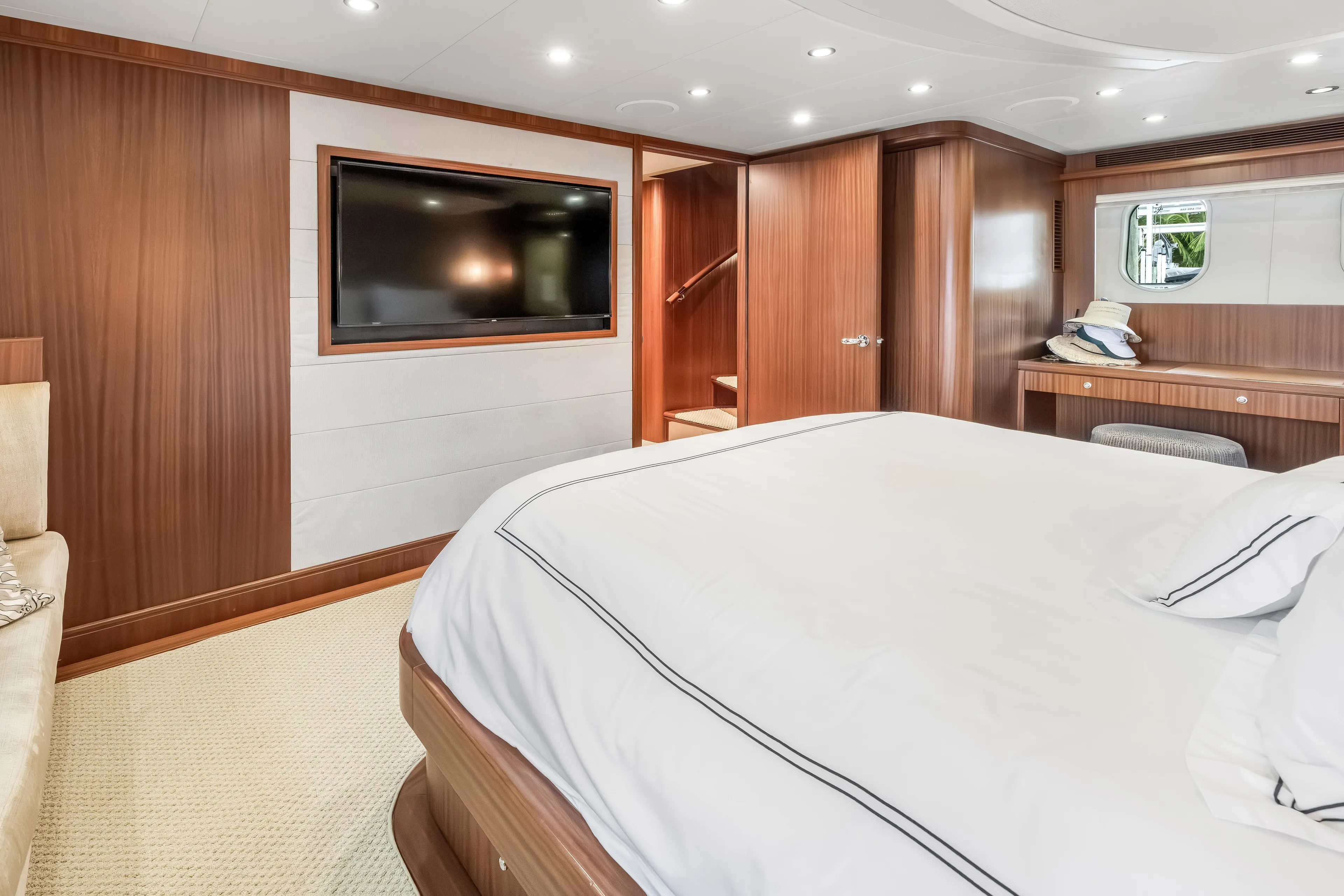 Aurora Yacht Photos Pics Luxurious bedroom interior of 2012 Cheoy Lee 84 Bravo yacht with wood paneling and TV.