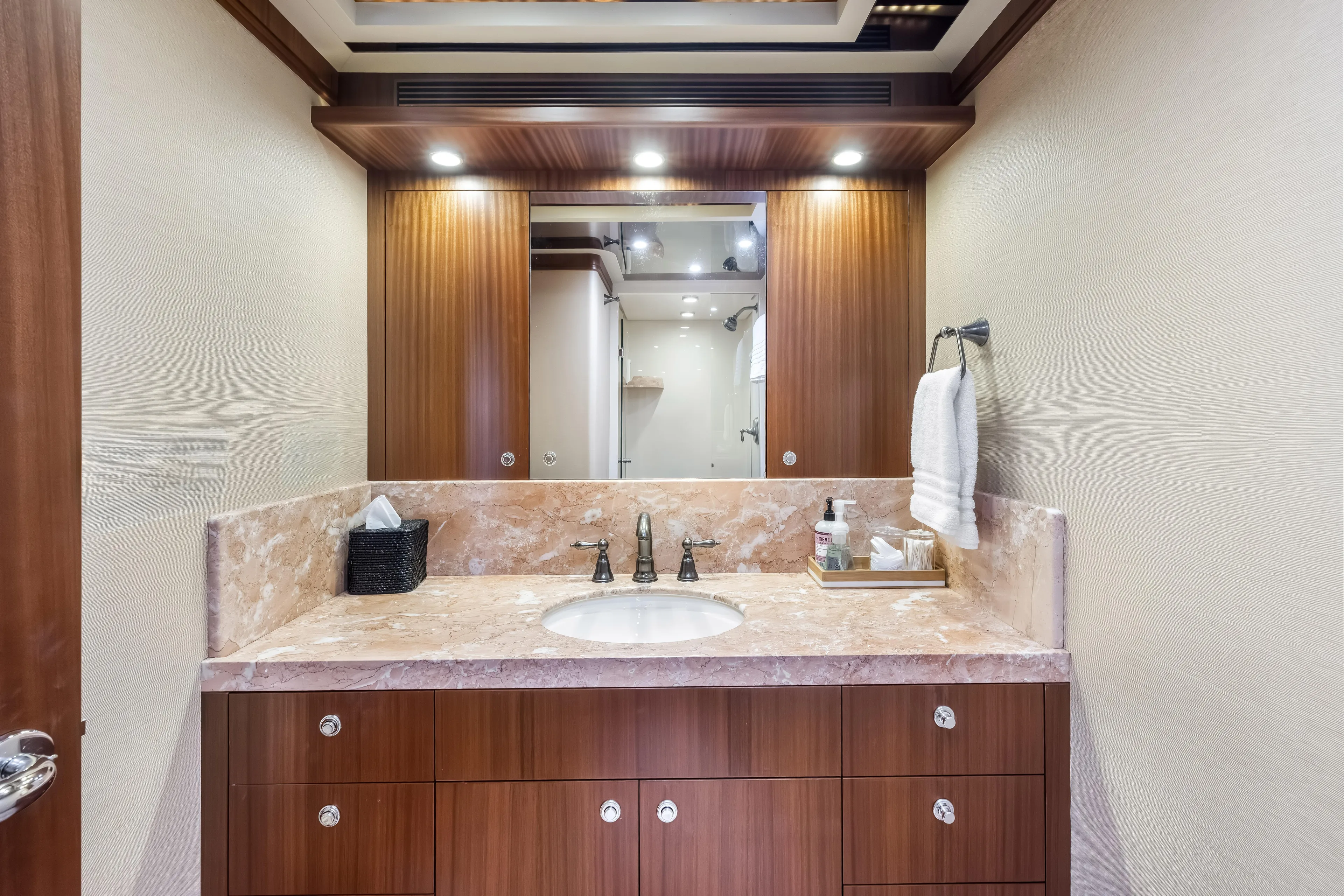 Aurora Yacht Photos Pics Luxurious bathroom interior on 2012 Cheoy Lee 84 Bravo yacht, featuring marble countertop and wooden cabinetry.