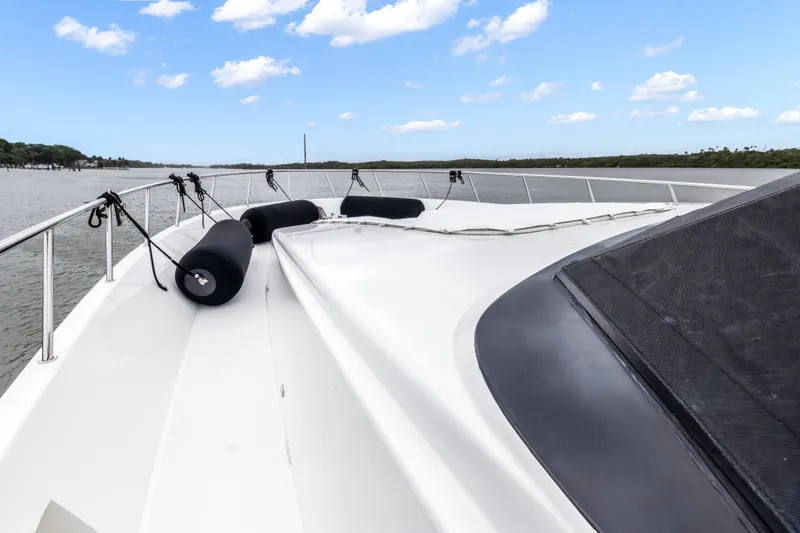 Aurora Yacht Photos Pics Bow view of 2012 Cheoy Lee 84 Bravo yacht on a calm waterway.