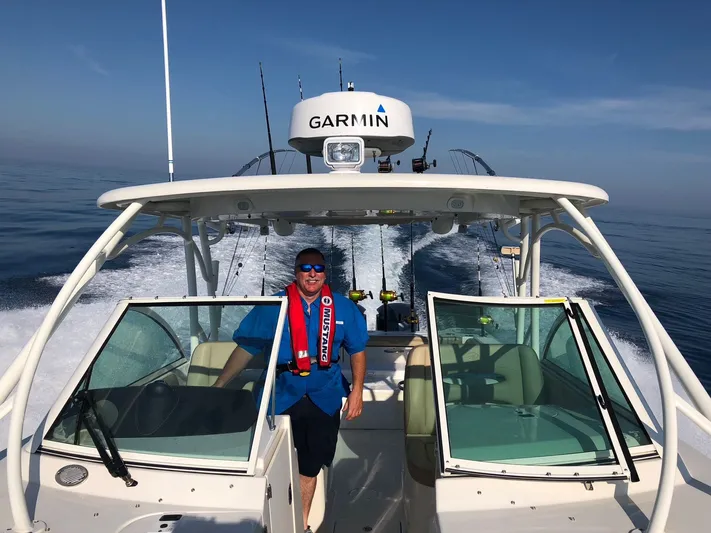  Yacht Photos Pics Man on a 2017 Sailfish 325 Dual Console boat at sea.