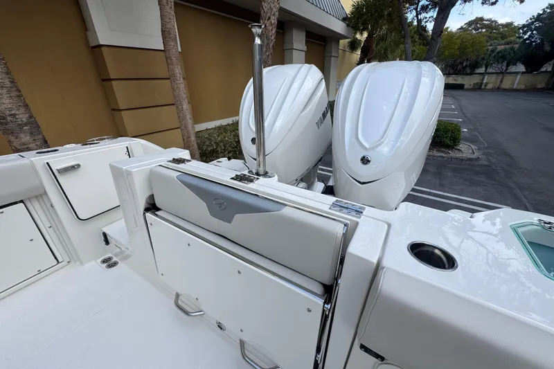  Yacht Photos Pics 2026 Sailfish 312 CC boat with dual outboard engines in a parking area.