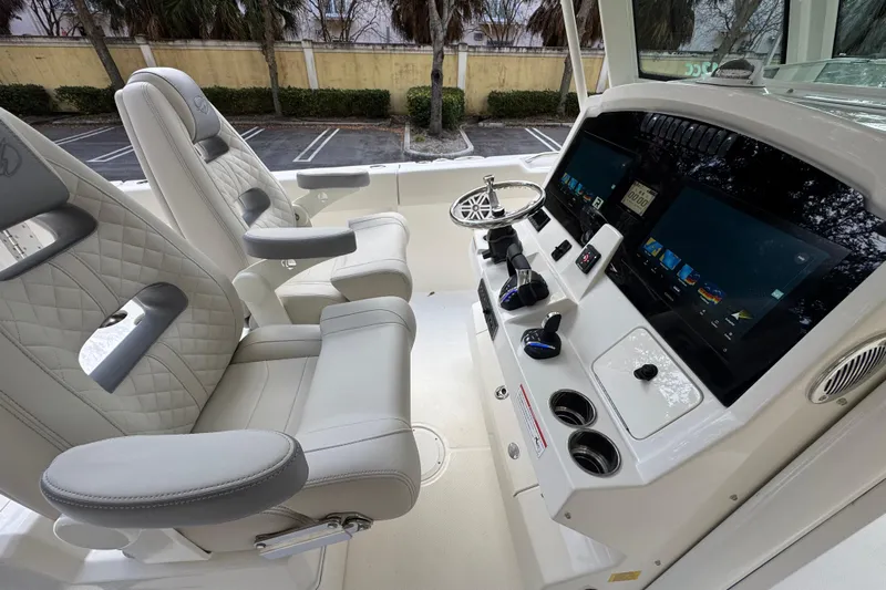  Yacht Photos Pics Luxurious interior of 2026 Sailfish 312 CC boat with advanced control panel and plush seating.