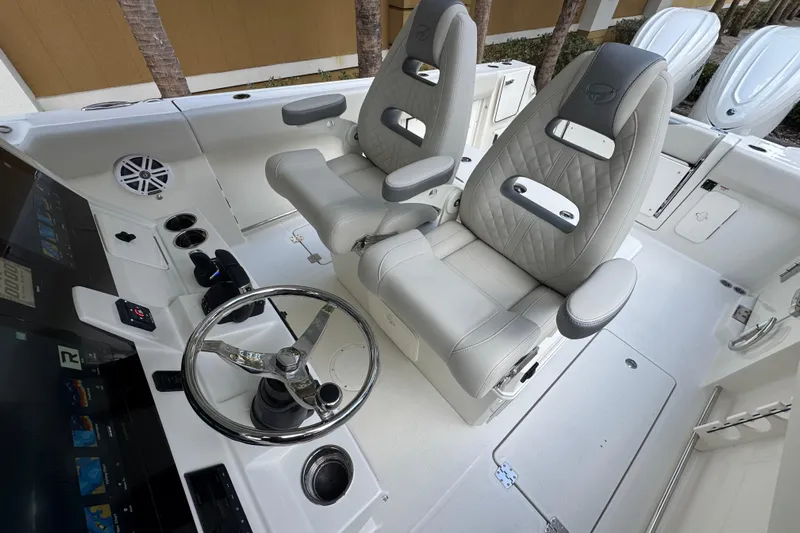  Yacht Photos Pics 2026 Sailfish 312 CC boat interior with dual captain's chairs and modern steering console.
