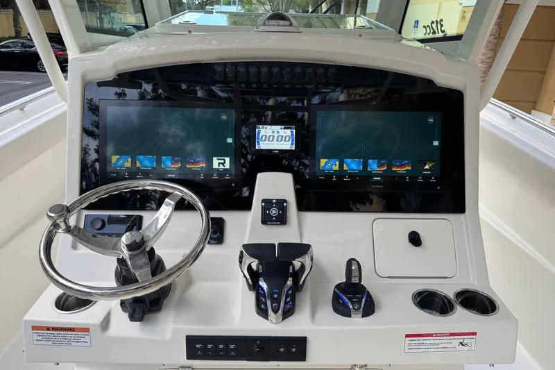  Yacht Photos Pics 2026 Sailfish 312 CC boat dashboard with dual screens and modern controls.