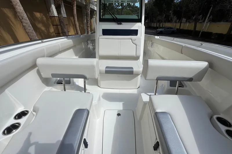  Yacht Photos Pics 2026 Sailfish 312 CC boat interior with white seating and cup holders.