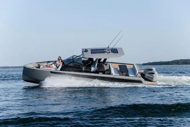  Yacht Photos Pics 2026 Virtue V10 T-Top boat cruising on open water with passengers enjoying the ride.