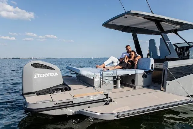  Yacht Photos Pics Couple relaxing on 2026 Virtue V10 T-Top boat with Honda engine on open water.