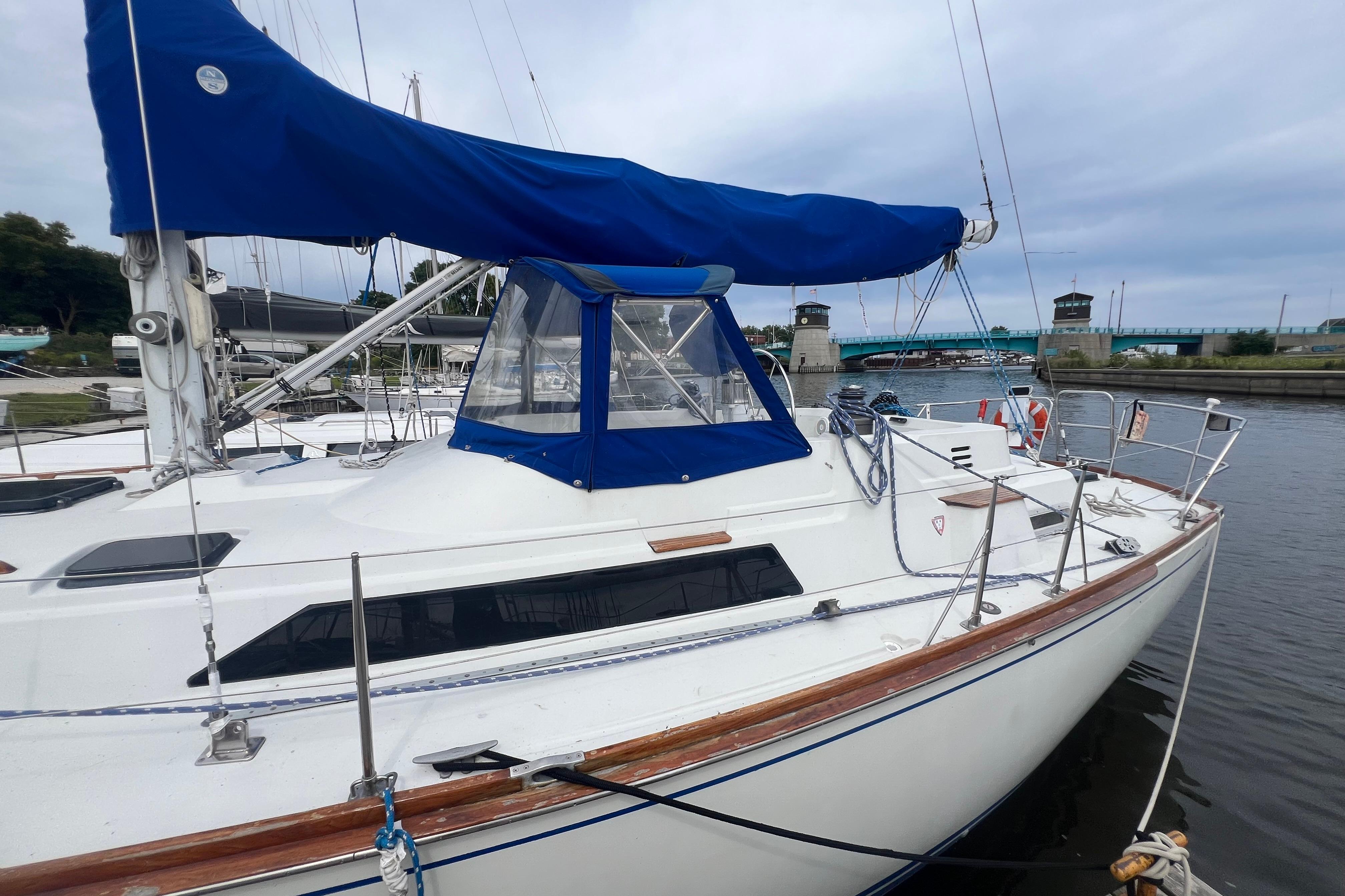 1985 C&C Landfall 39 sailboat docked, featuring blue sail cover and sleek design.