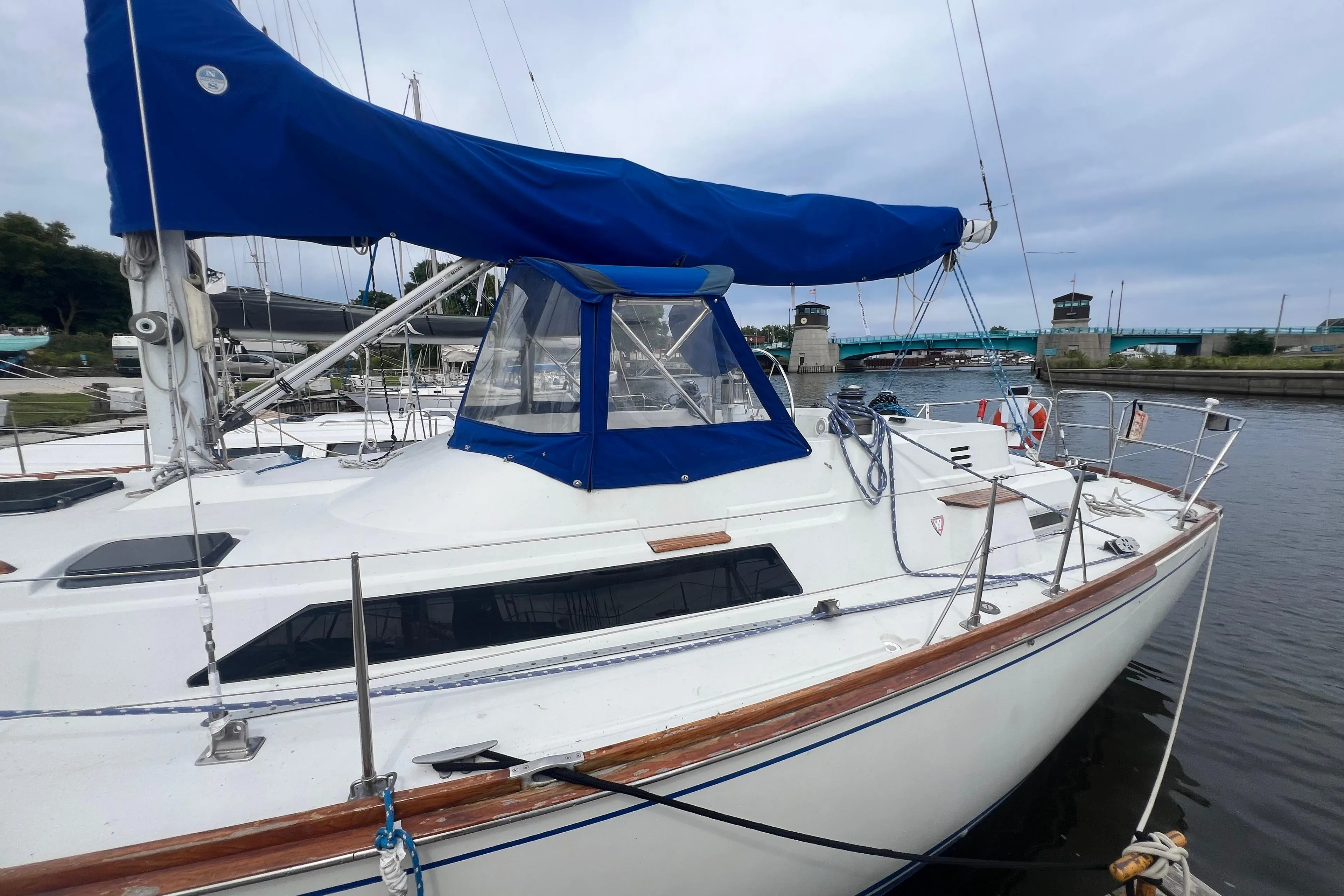 1985 C&C Landfall 39 sailboat docked, featuring blue sail cover and sleek design.