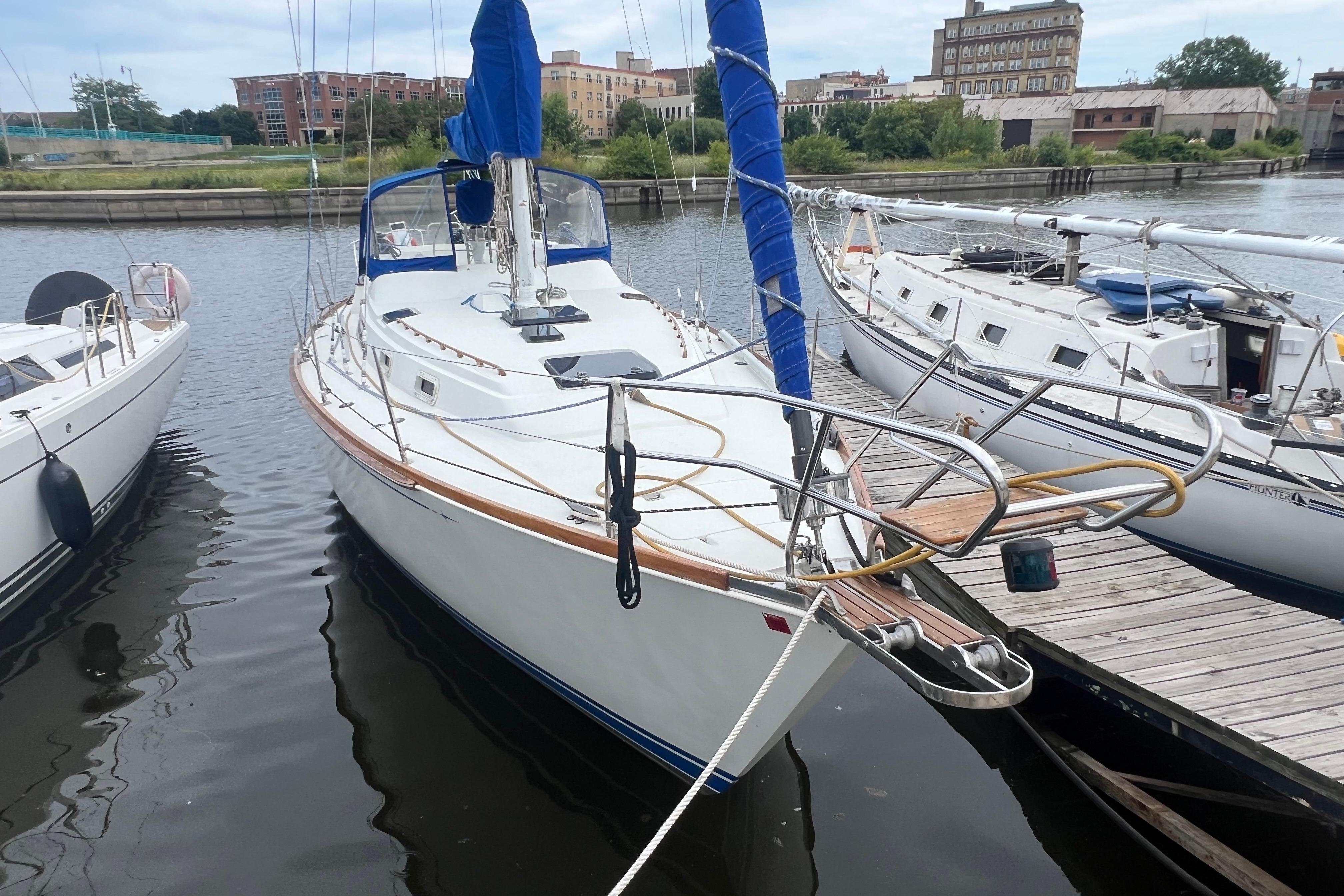 1985 C&C Landfall 39 sailboat docked at marina, surrounded by other boats.