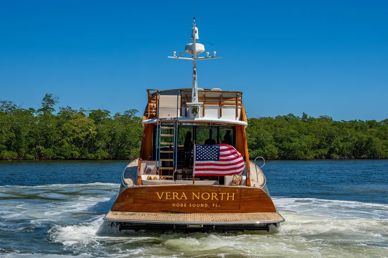 Vera North Yacht Photos Pics 2021 Hinckley Talaria yacht "Vera North" cruising in Hobe Sound, Florida, with American flag.