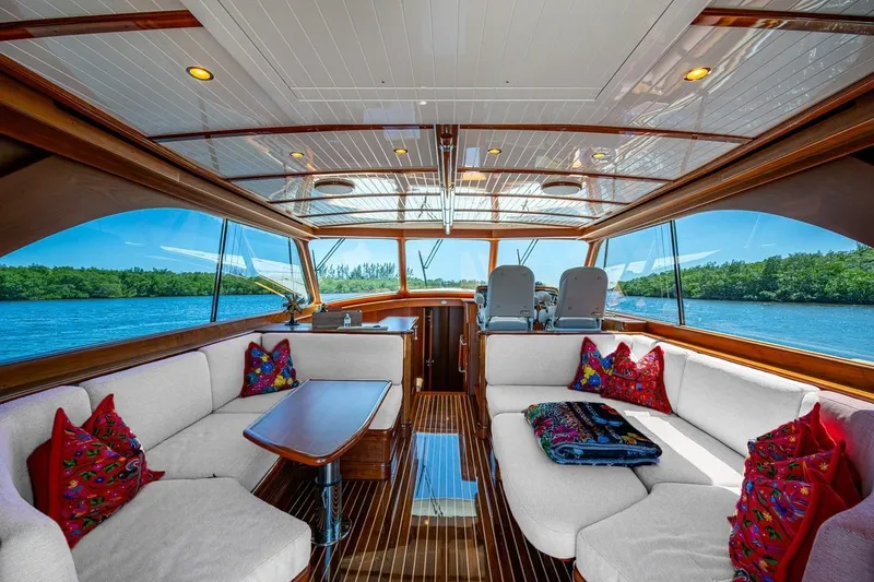 Vera North Yacht Photos Pics Luxurious 2021 Hinckley Talaria yacht interior with elegant seating and scenic water views.