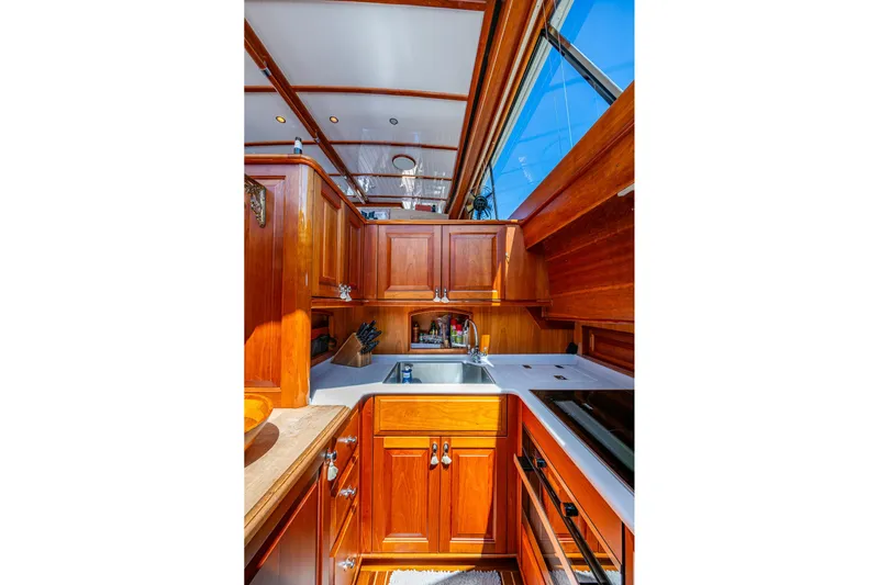 Vera North Yacht Photos Pics Luxurious 2021 Hinckley Talaria yacht kitchen with elegant wood cabinetry and modern appliances.