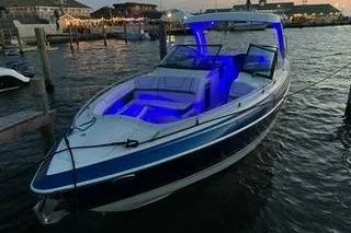  Yacht Photos Pics 2018 Formula 350 Crossover Bowrider with blue interior lighting docked at sunset.