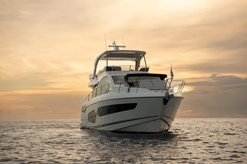 Gaia Yacht Photos Pics 2022 Sunseeker Manhattan 68 yacht at sunset on calm sea.