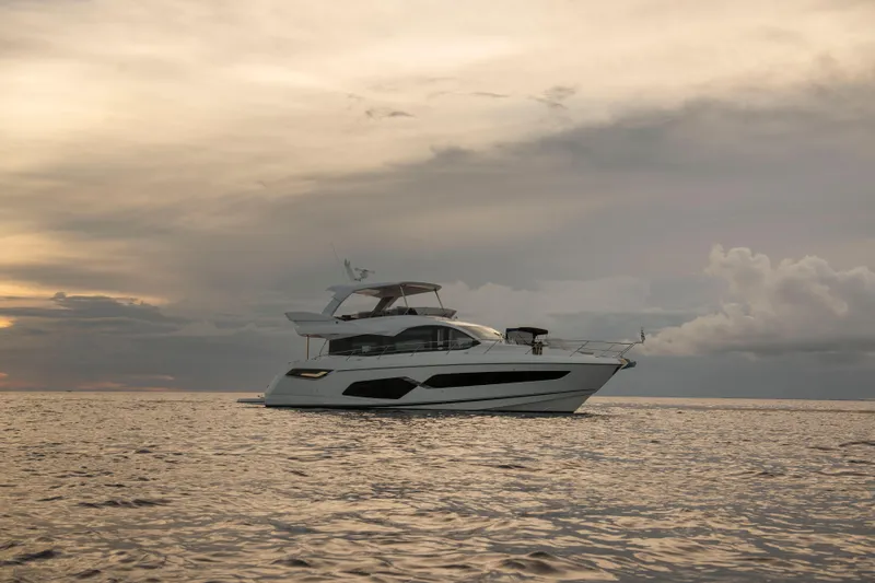 Gaia Yacht Photos Pics 2022 Sunseeker Manhattan 68 yacht on calm sea at sunset.