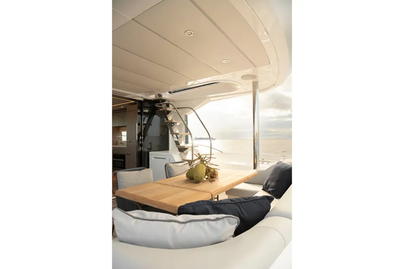 Gaia Yacht Photos Pics Luxurious Sunseeker Manhattan 68 yacht interior, featuring elegant seating and a wooden table, 2022 model.
