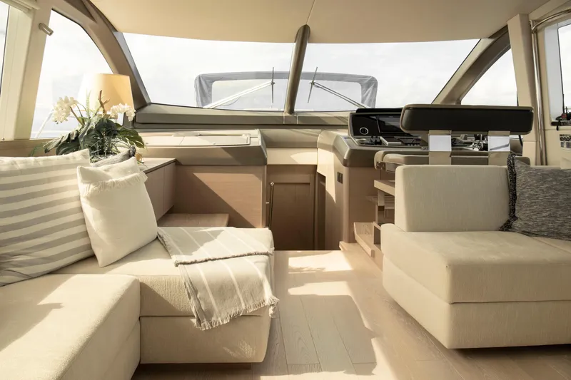 Gaia Yacht Photos Pics Luxurious interior of 2022 Sunseeker Manhattan 68 yacht with elegant seating and helm.