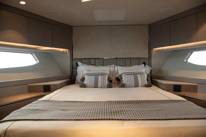 Gaia Yacht Photos Pics Luxurious bedroom interior of 2022 Sunseeker Manhattan 68 yacht, featuring elegant bedding and modern design.