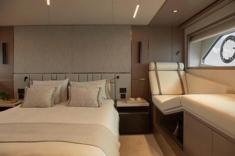Gaia Yacht Photos Pics Luxurious bedroom interior of 2022 Sunseeker Manhattan 68 yacht, featuring elegant design and comfortable seating.