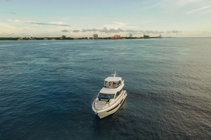 Gaia Yacht Photos Pics 2022 Sunseeker Manhattan 68 yacht cruising on open water near coastline.