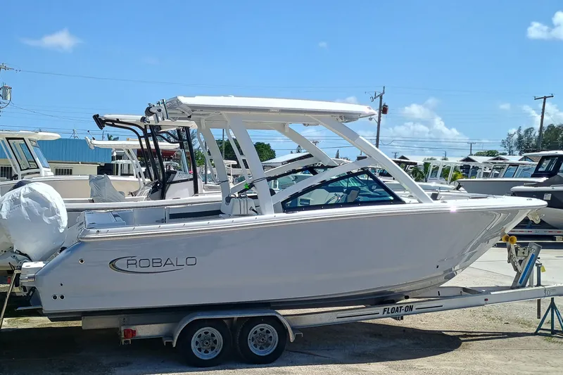 257-155 Yacht Photos Pics 2025 Robalo R257 Dual Console boat on trailer, side view, sunny day.