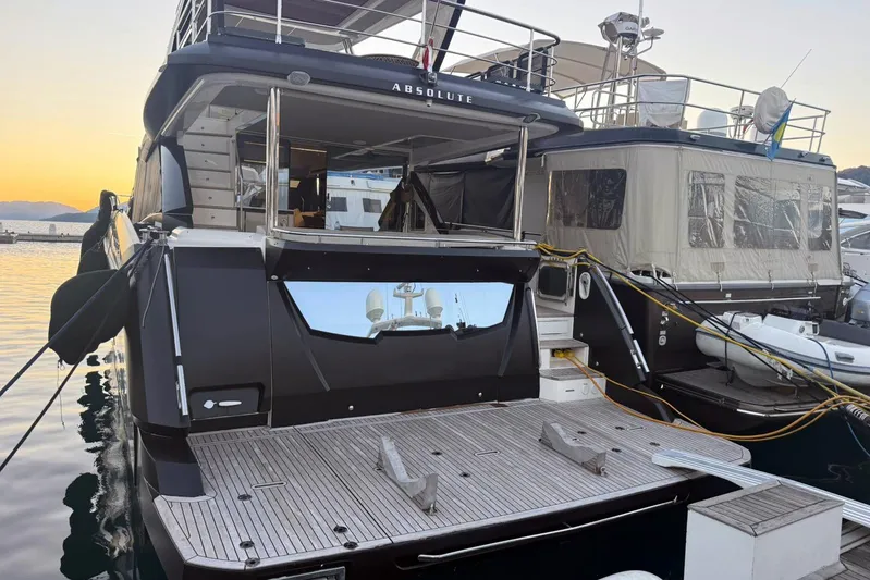 3775 Yacht Photos Pics Luxury 2019 Absolute 62 Fly yacht docked at sunset, showcasing sleek design.