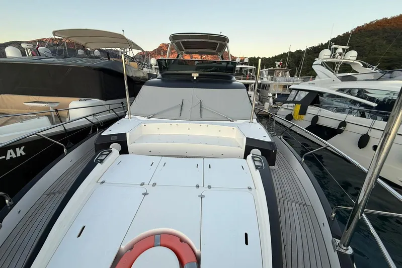 3775 Yacht Photos Pics 2019 Absolute 62 Fly yacht docked among other luxury boats.